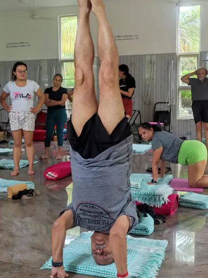 Holding Sirsasana (Headstand) during the International Yoga Festival at our Ramanagara centre. Students observe the stability and balance required for inversions.