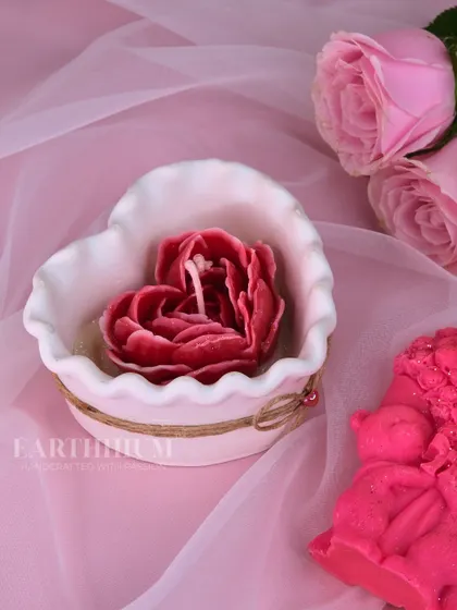 Poured with love, and shaped like it too. This heart-shaped candle features a beautiful red rose at its center, making it a perfect romantic gift.