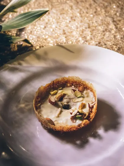A close-up of a Ghevar-inspired tart, a modern take on a traditional Indian dessert.