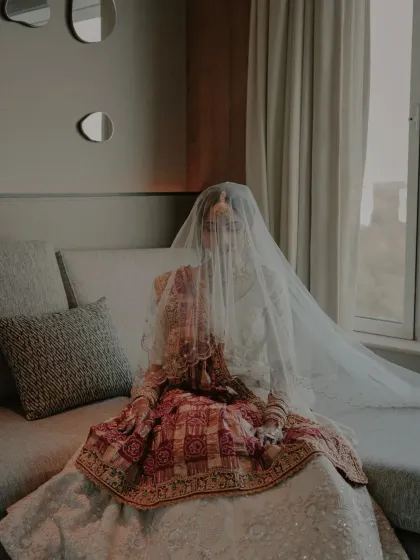 A mysterious and beautiful shot of the bride with her face covered by her veil, creating a soft and ethereal look.