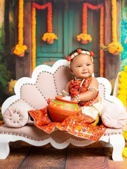 Our little Gopi holds a pot of butter in this adorable Krishna-themed setup. I provide all the costumes and props for these elaborate and culturally rich photoshoots.