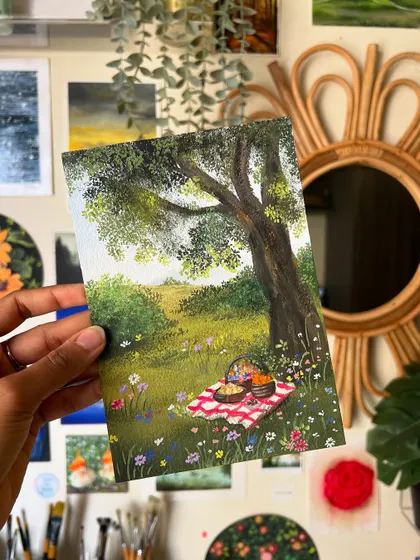 The picnic painting held up against my art wall, a dreamy addition to my collection of landscapes.