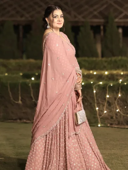 The same guest at night, with the fairy lights in the background adding a magical touch to her look.