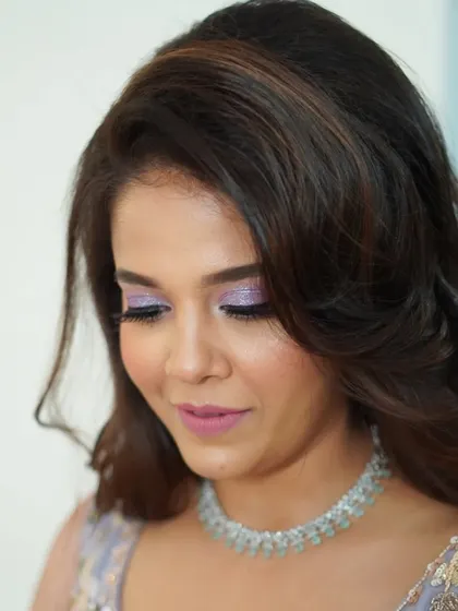 This downward glance shows the beautiful detail of the lilac glitter eyeshadow. It's a perfect example of how I love to play with color and texture to create a custom look.