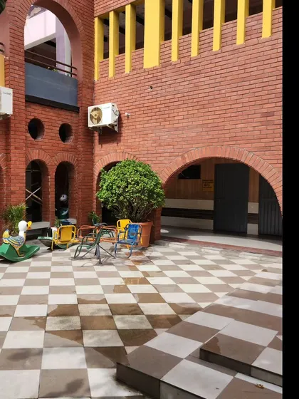 A corner of the courtyard with rocking horses and seating, highlighting the child-friendly scale of the design. Every element is chosen to encourage play and social interaction in a comfortable setting.