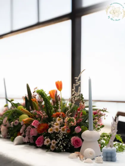 A tablescape detail for a beachside cocktail event. We used seashells, coral, and soft blue candles to bring the coastal element into the decor.