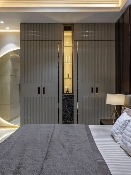 A duplicate of image 16, this view emphasizes the play of light and shadow on the textured walls and the sleek, integrated design of the storage and display areas.