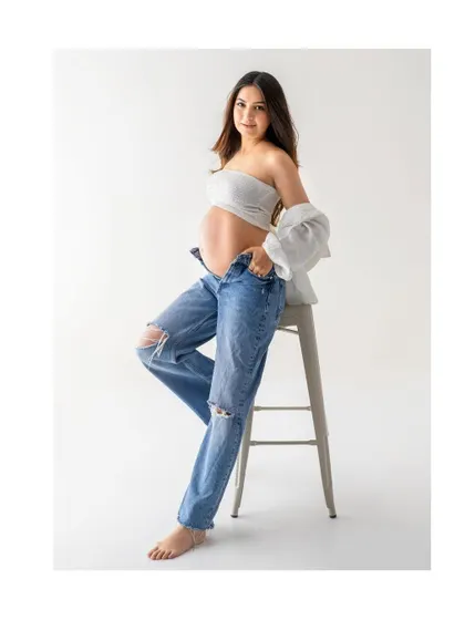 A classic seated portrait on a stool. This simple setup is perfect for creating a relaxed yet beautifully composed solo maternity shot.