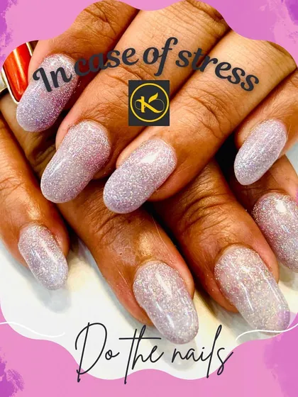A full set of oval-shaped nail extensions completely covered in a fine, holographic silver glitter. This look is perfect for catching the light and adds a fun, dazzling effect to your hands.