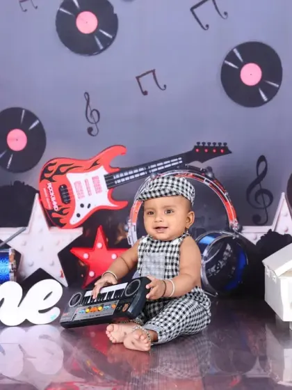 A full view of the music-themed setup, with a baby boy playing a toy keyboard. This dynamic and creative theme is perfect for little ones with a love for music.