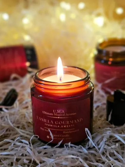 The 'Vanilla Gourmand' Amber Jar Candle, lit and glowing. This warm and comforting scent is the perfect companion for cozy moments. It's not just vanilla, it's very vanilla!