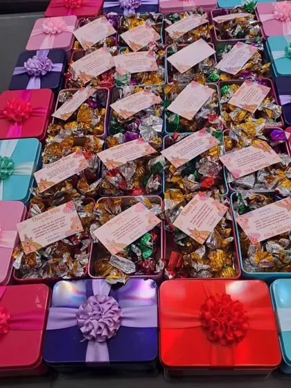 Another view of the vibrant, budget-friendly chocolate tins. I can provide them in various colors like pink, purple, red, and teal to match any party theme.