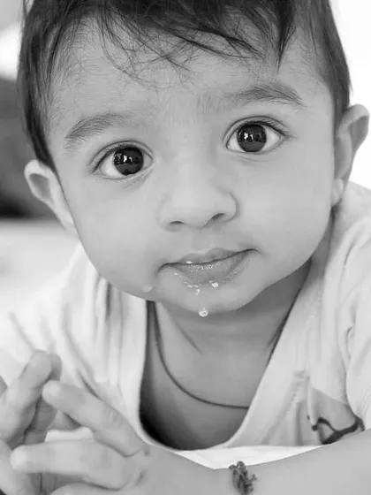 Color is descriptive, but black and white is interpretive. This close-up monochrome portrait of a baby captures the innocence and detail in their expression.