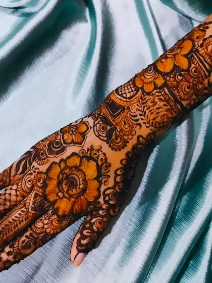 A close-up of the floral design on one hand, showing the intricate details.