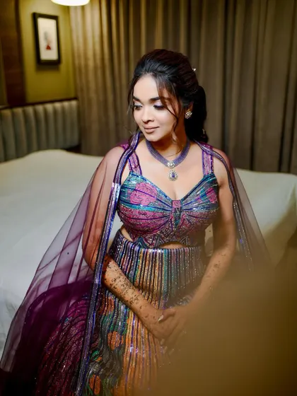 A quiet moment before the festivities. This shot highlights the soft sparkle and intricate details of the sangeet makeup.