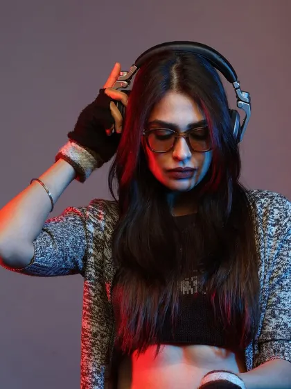 Adjusting my headphones in a studio setting. This shot captures a moment of preparation and focus, getting into the zone before a performance.