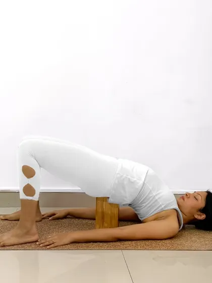 Here is a detailed breakdown of how to practice Setu Bandhasana. Using a block under your sacrum can turn this into a wonderfully restorative and supported backbend.