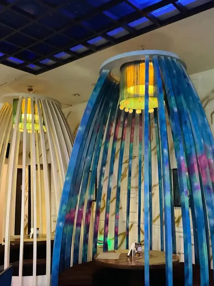 I also added color and texture to these unique birdcage-style seating pods at Drool Kitchen. The abstract blue and green spray paint effect gives them a vibrant, artistic look.