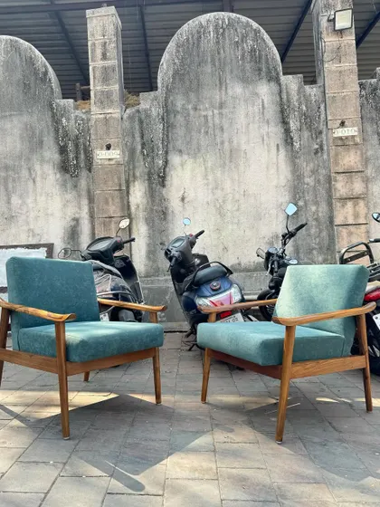 A clean, straight-on shot of the two teal lounge chairs.