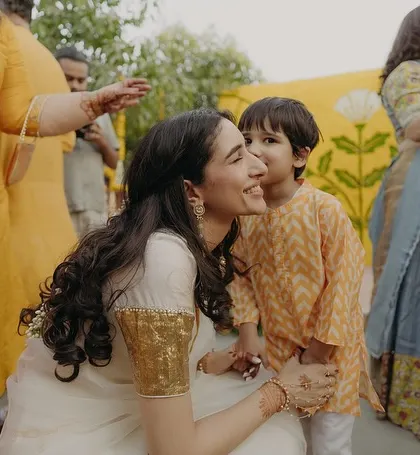 A sweet, candid moment between the bride and a young family member during the Haldi celebrations.