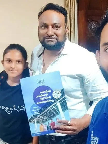 A family with a young girl holding our "Built for Generations" booklet.