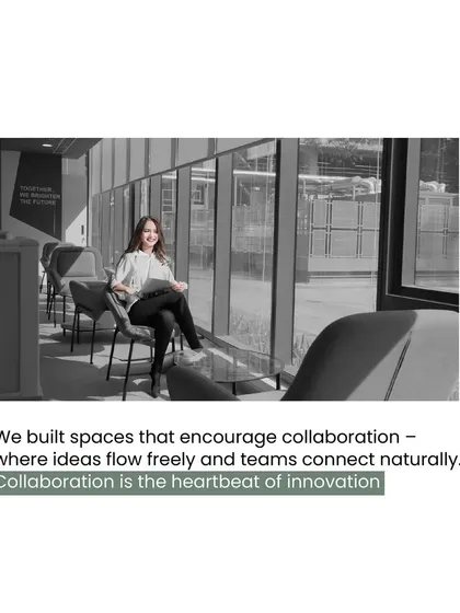 A black and white shot of a lounge area with large windows, illustrating our principle of building spaces that encourage collaboration and allow ideas to flow freely.