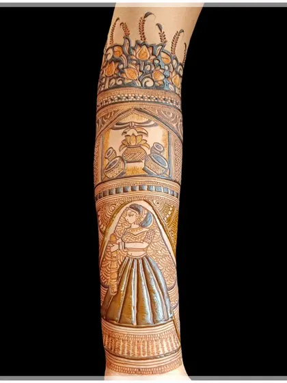 This arm piece features a bride figure below a band of traditional kalash pots and a floral border, showcasing how different elements are stacked in a full design.