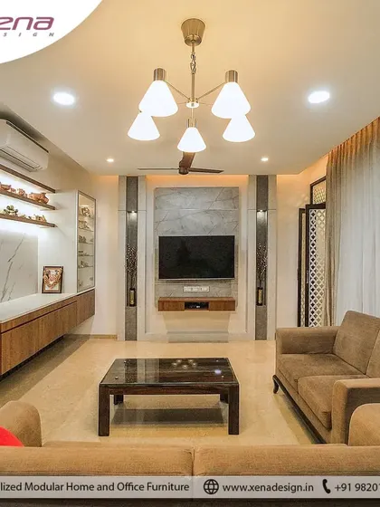 A comfortable and earthy living room design with a large sofa, a central coffee table, and a custom media wall that includes open shelving for decor. The focus here was on creating a warm, family-friendly space.
