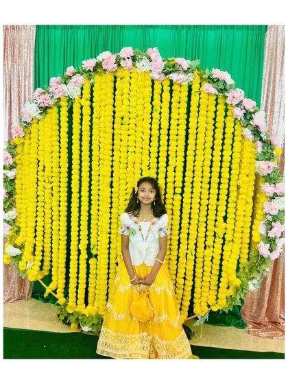 Looking bright and sunny for a Haldi or Mehendi ceremony. Our client is wearing a custom yellow lehenga with a contrasting white blouse that has delicate floral maggam work around the neckline.
