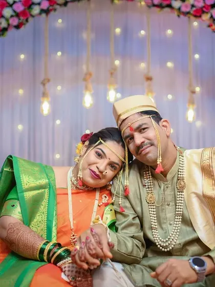 A sweet seated portrait of the couple after the wedding rituals, holding hands and smiling.