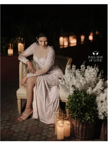 Creating a romantic and cozy atmosphere with soft, delicate lighting. The couple is surrounded by dozens of candles, casting a warm glow that is perfect for intimate reception photos.