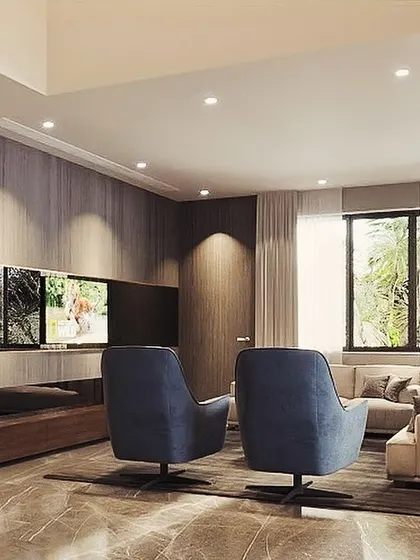 A cozy yet sophisticated media room setup. The wood-paneled wall adds warmth and texture, while the comfortable swivel armchairs are perfectly positioned for an immersive viewing experience.