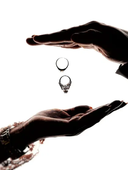 A creative and symbolic portrait of commitment. This high-contrast silhouette shot focuses on the rings, representing the promise and the bond you share, captured in an artistic and minimalist style.