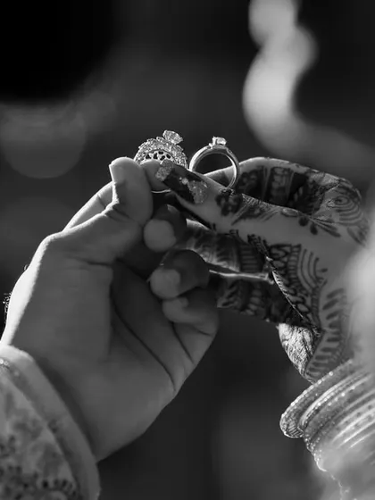 A classic black and white shot of the engagement rings. This timeless style highlights the symbolism and importance of the moment.