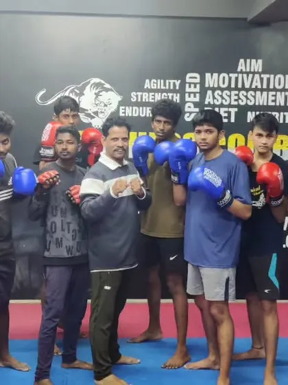 A group of my boxers, Team Panthers, posing together after a tough training session. There is a strong bond of camaraderie and respect among my students.