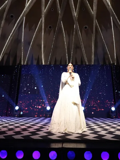 A full-length view of my elegant white outfit for a sangeet, perfectly complementing the checkered dance floor and starry backdrop.