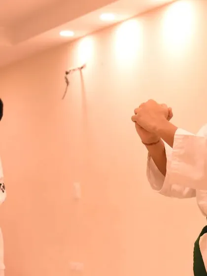 Two students execute a pattern in unison, their focus unwavering during the exam.