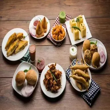 A platter showcasing the variety available in our evening snacks menu for offices. We cater to different tastes with a mix of fried, steamed, and savory items like samosas, dhokla, and bread pakora.