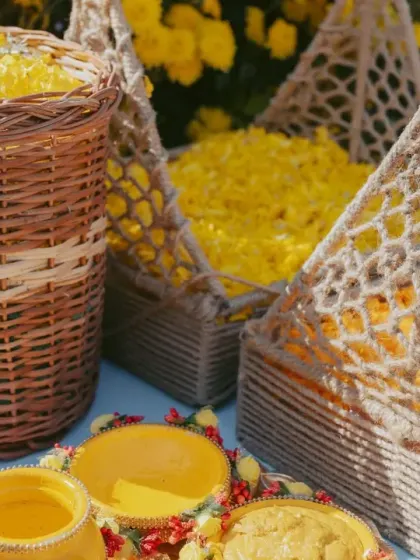 Baskets of fresh yellow flower petals, ready for the Haldi ceremony celebrations.