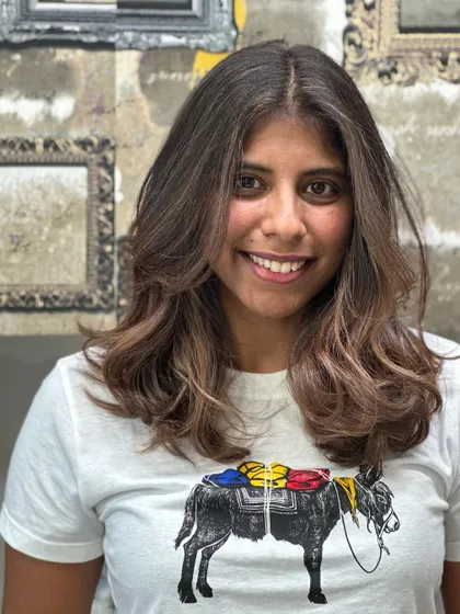 The client looking happy and confident with her new hair.