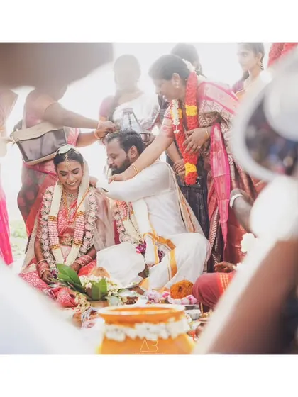 Another angle of a traditional ceremony, showing the interaction between the couple and the priest. The soft, bright lighting gives the scene an airy and timeless feel.