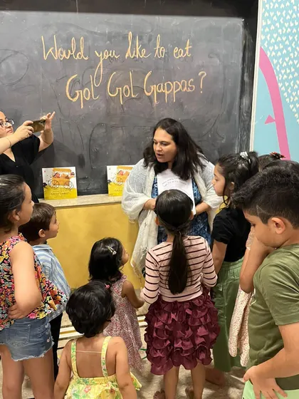 The kids gathered around, excited to learn more about gol gappas. These themed sessions are a great way to engage all their senses.