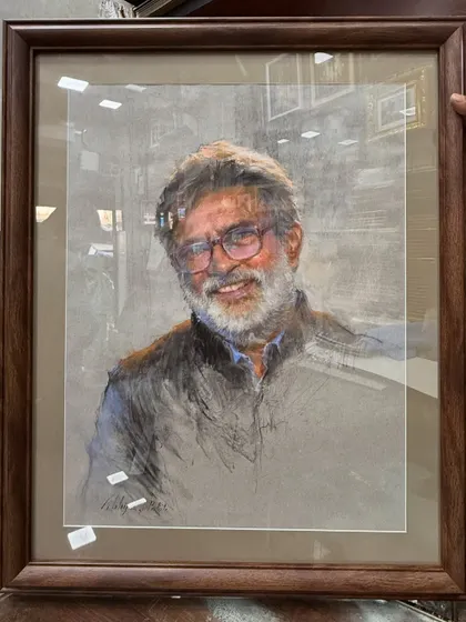 The framed soft pastel portrait of Mr. Vasudeo Kamath, ready for presentation.