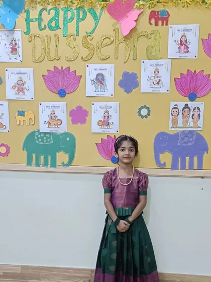 Another one of our students in beautiful traditional attire for the Dussehra festival, posing in front of our festive bulletin board.