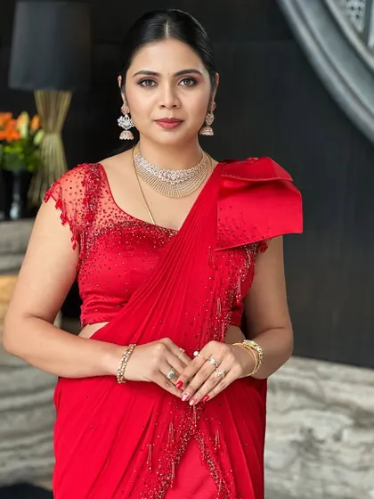 A portrait of the client, her direct gaze and confident smile perfectly matching her bold, red-carpet-ready look.