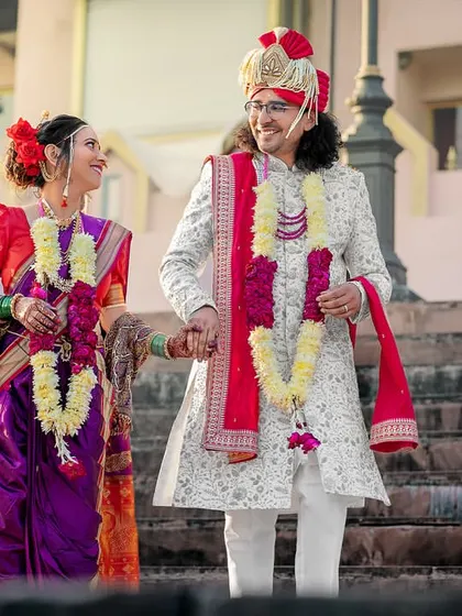 Hand in hand, they walk down the steps of the ghat, beginning their new life together. A beautiful moment from a Ganga-side wedding.
