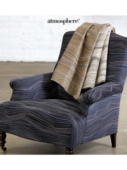 Aptly named 'String Theory', this fabric creates a stunning 3D effect with vibrant yarns embroidered on soft chenille. I select such innovative textiles to create truly unique, conversation-starting upholstered pieces.