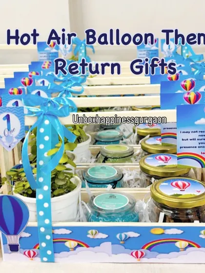 A full display of the 'Hot Air Balloon' themed return gifts, ready for a first birthday party.