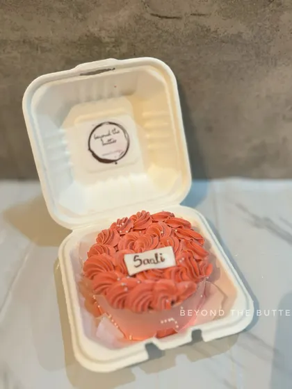 A pretty bento cake with pink piped roses and a custom name plaque for Saadi.