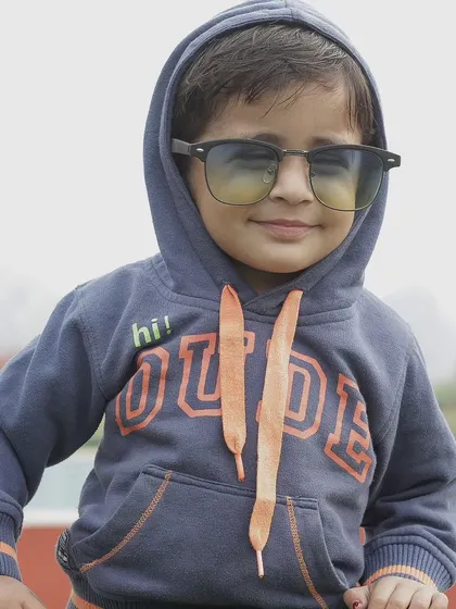 Capturing the cool and confident side of a child's personality. This portrait showcases how a simple prop like sunglasses and a hoodie can bring out a fun attitude.